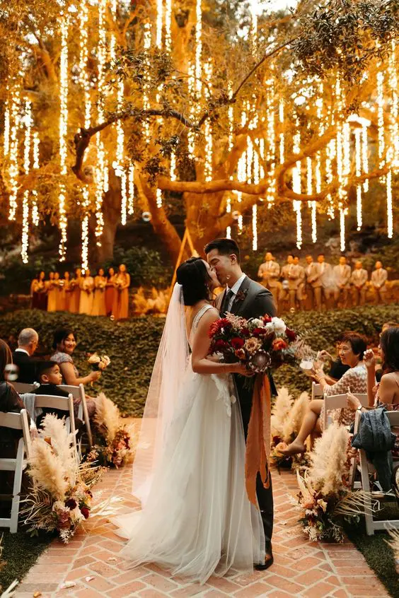 a-romantic-wedding-ceremony-space-with-lights-hanging-down-from-the-tree-make-the-space-magical-and-gorgeous-2029229